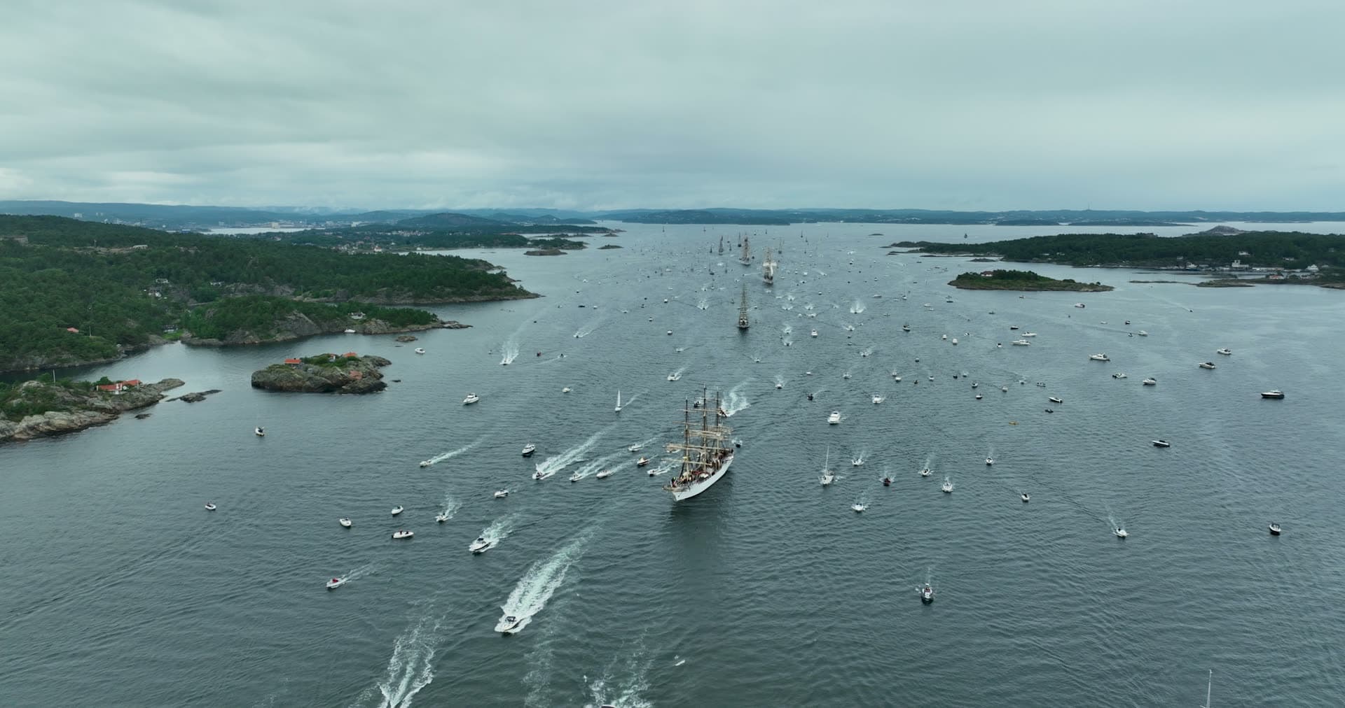 Tall ship surrounded by racing sailboat fleet, Kristiansand, Norway