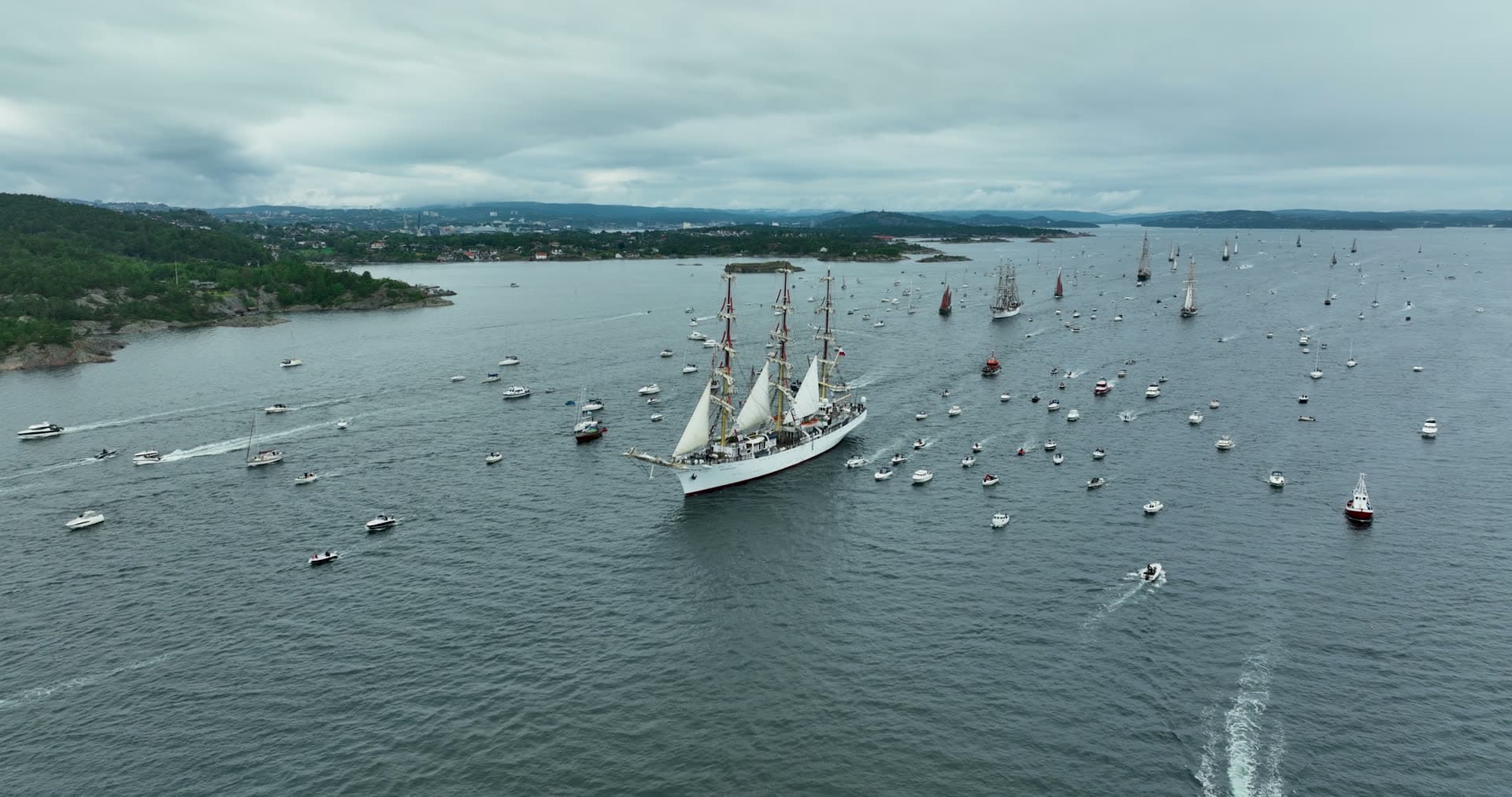 Three-masted tall ship surrounded by spectator boats, Kristiansand, Norway