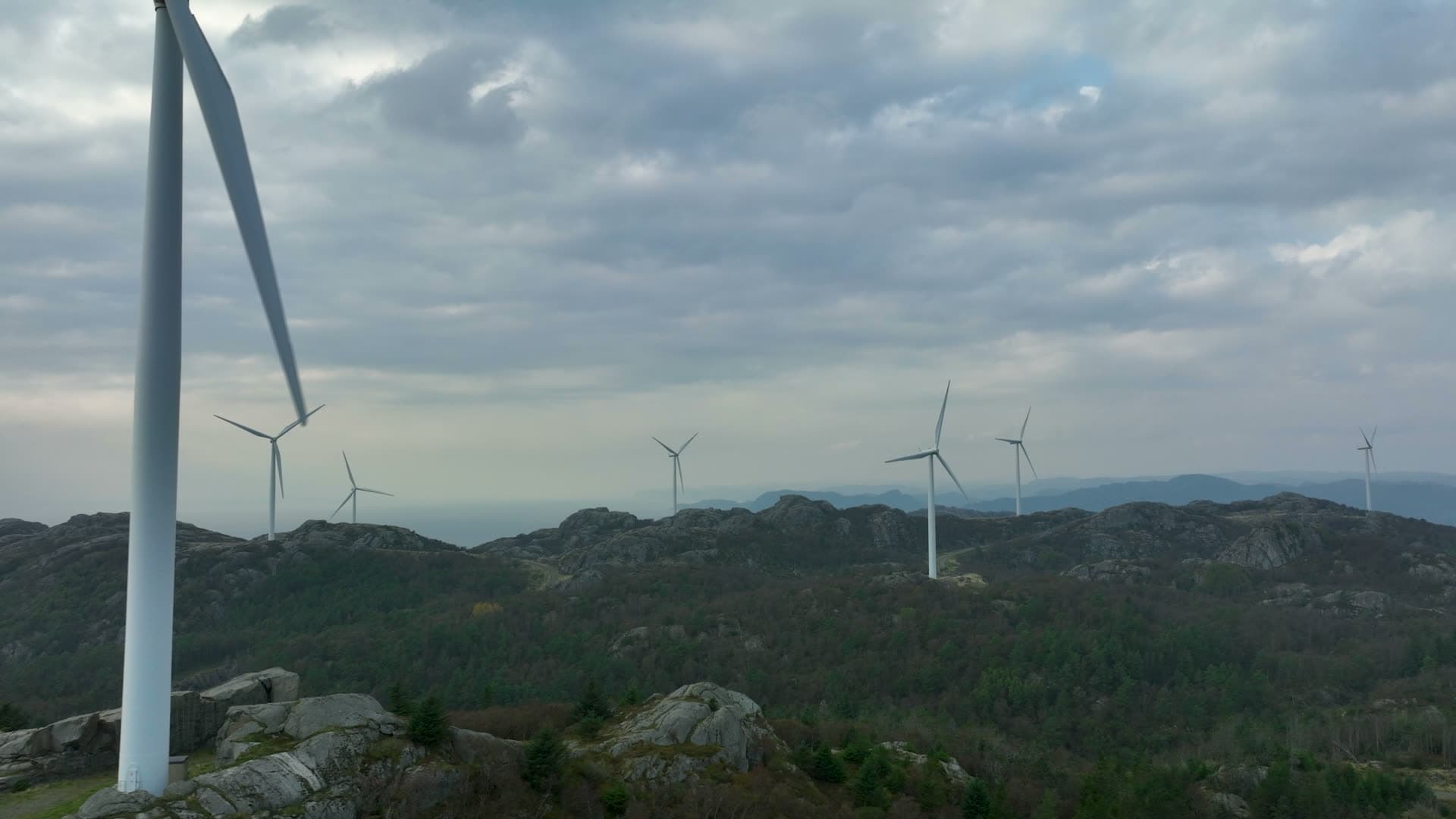White turbine tower ascending steeply upward, Lista, Norway