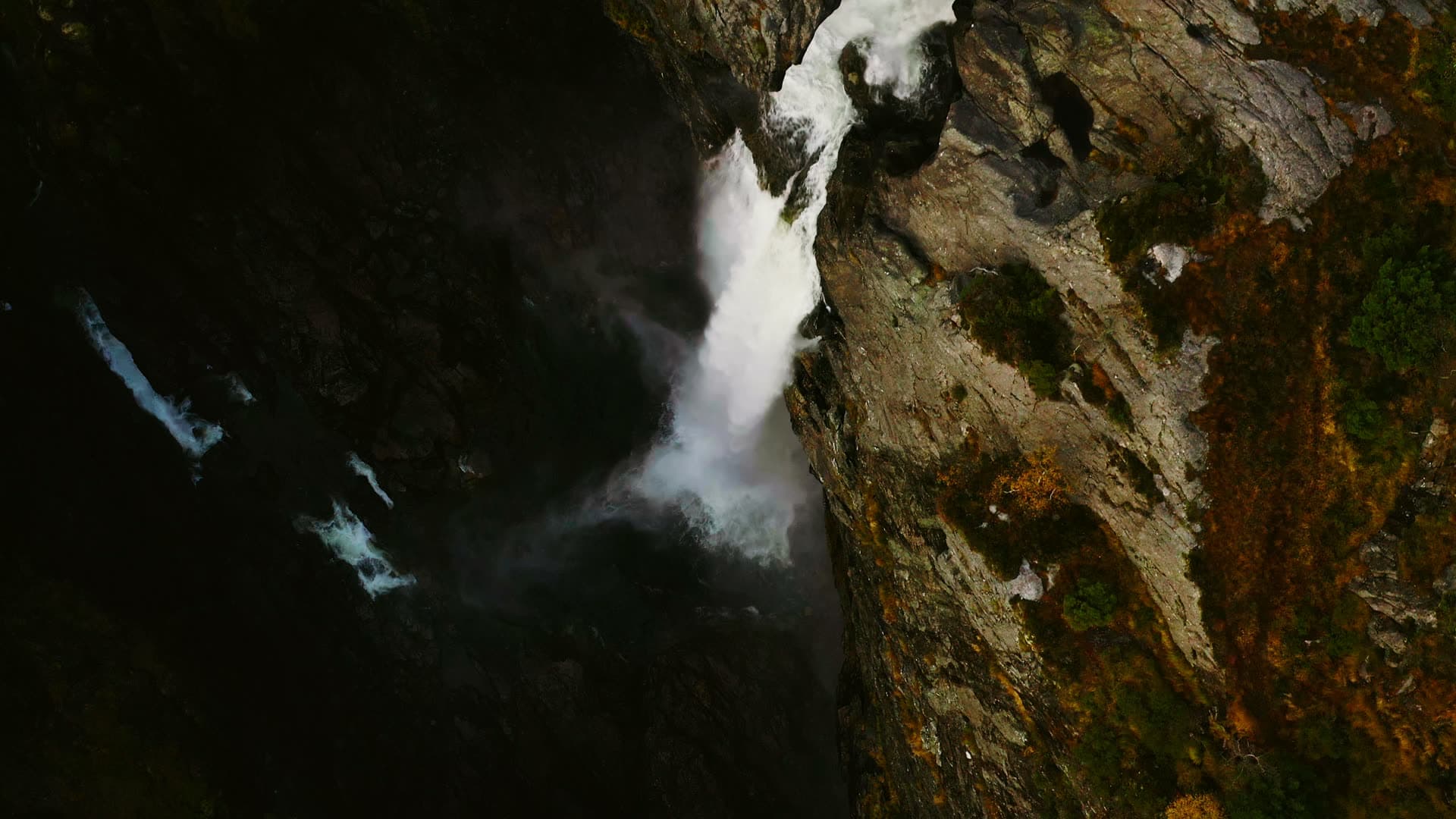 Waterfall plunging into narrow rock gorge, Månafossen, Norway