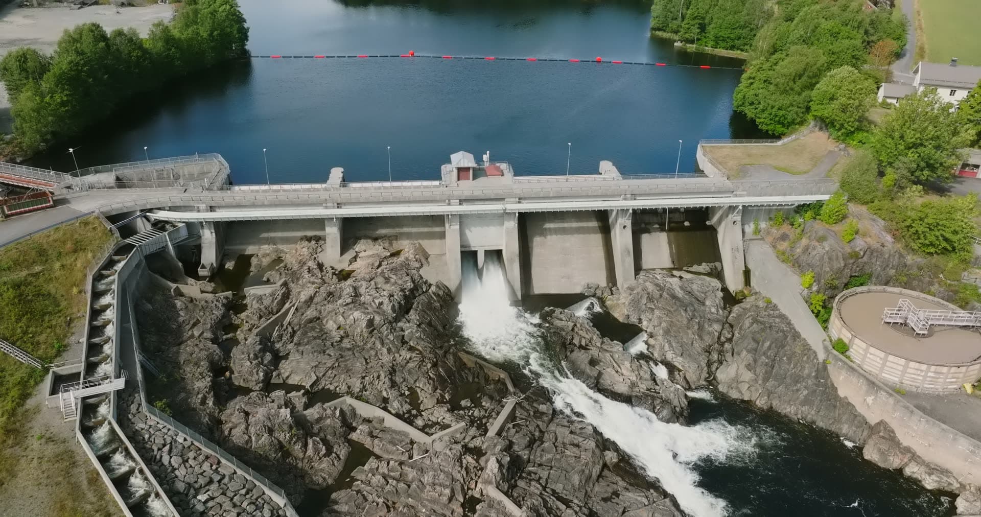 Water spilling from dam gates onto rocks, Rykene, Norway