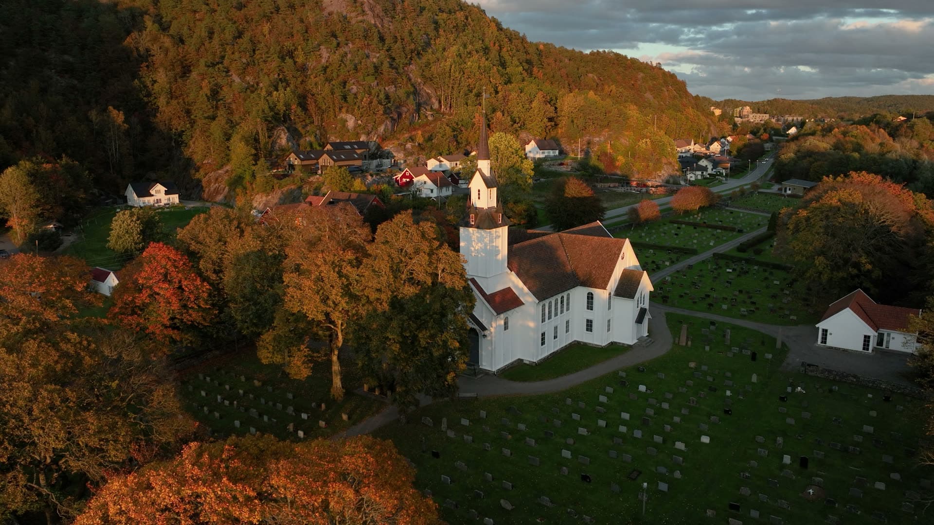 White church surrounded by golden autumn forest, Søgne, Kristiansand, Norway