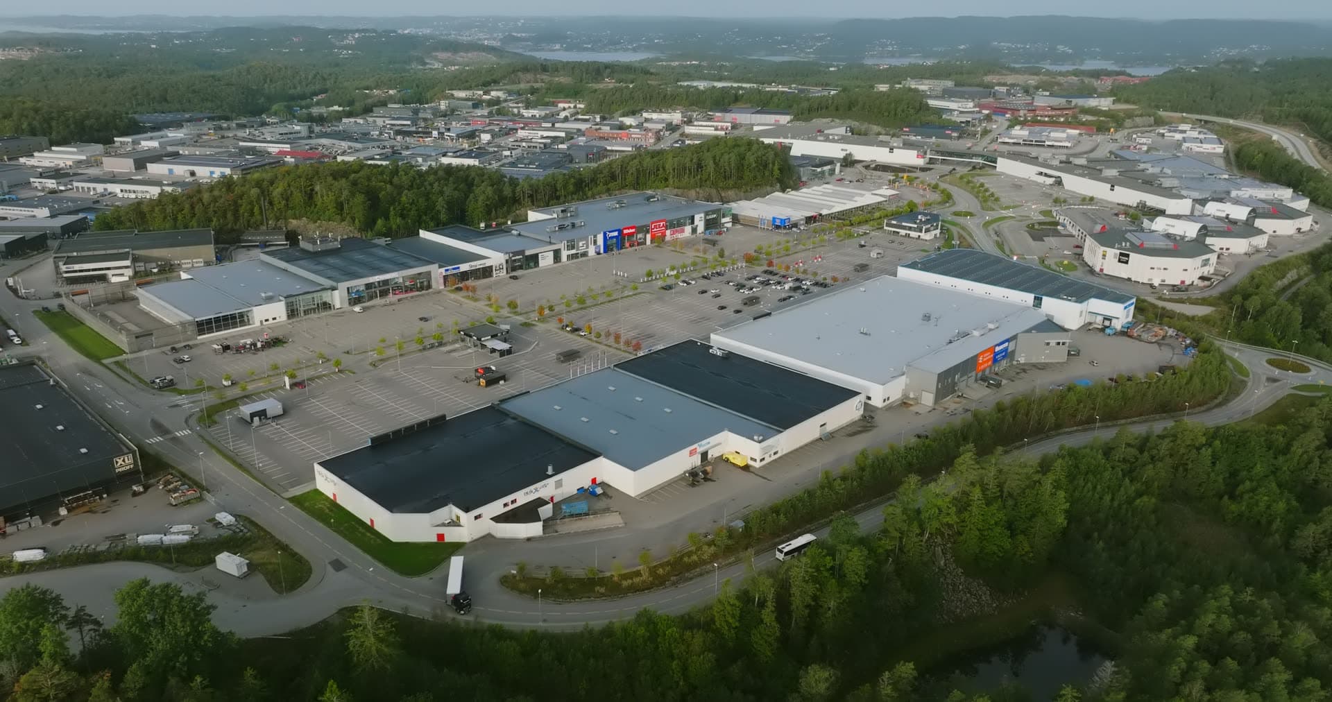 Modern retail complex with curved warehouse roof, Sørlandsparken, Kristiansand, Norway