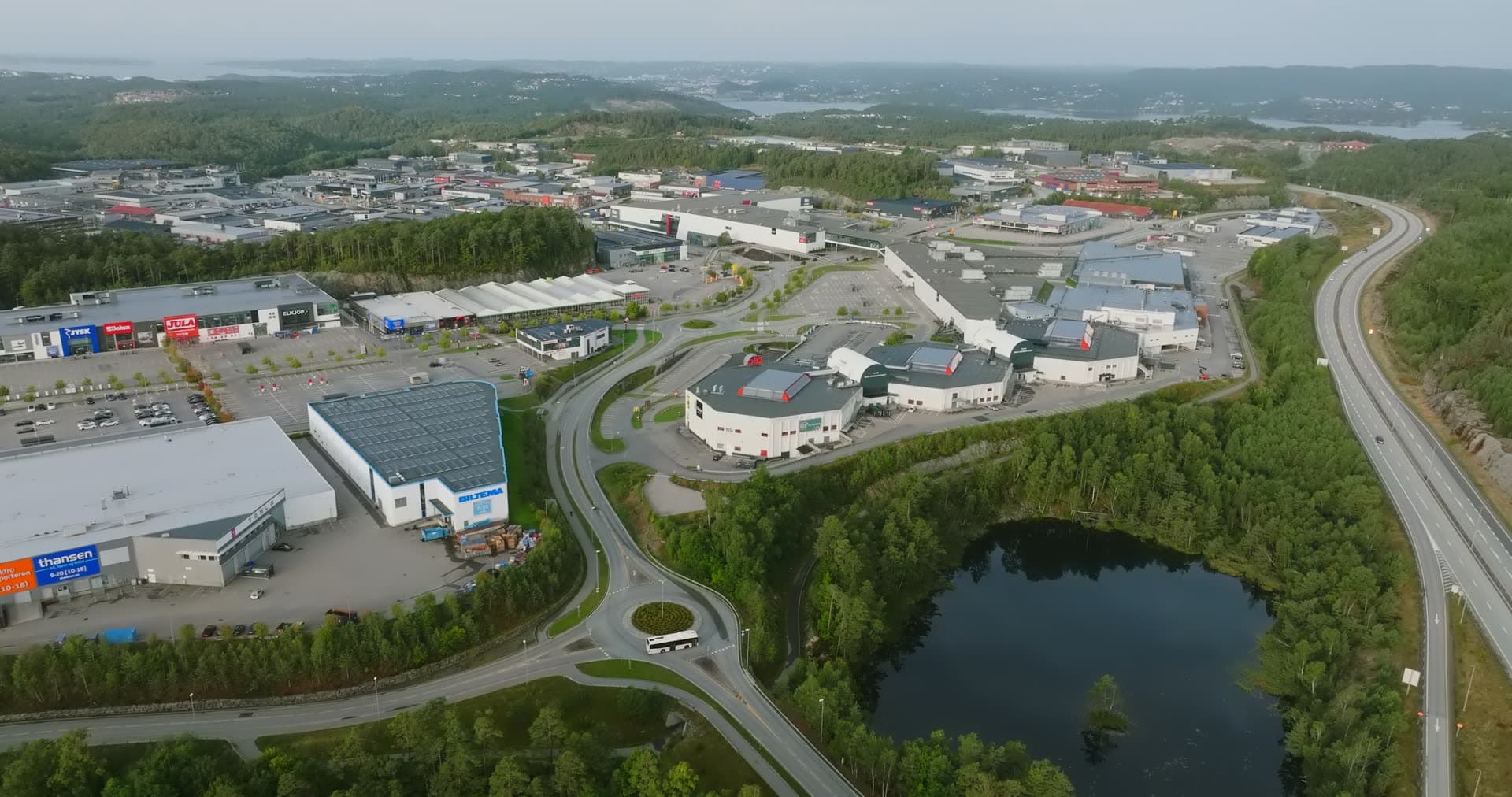 Pond-bordered retail park with curving access roads, Sørlandsparken, Kristiansand, Norway