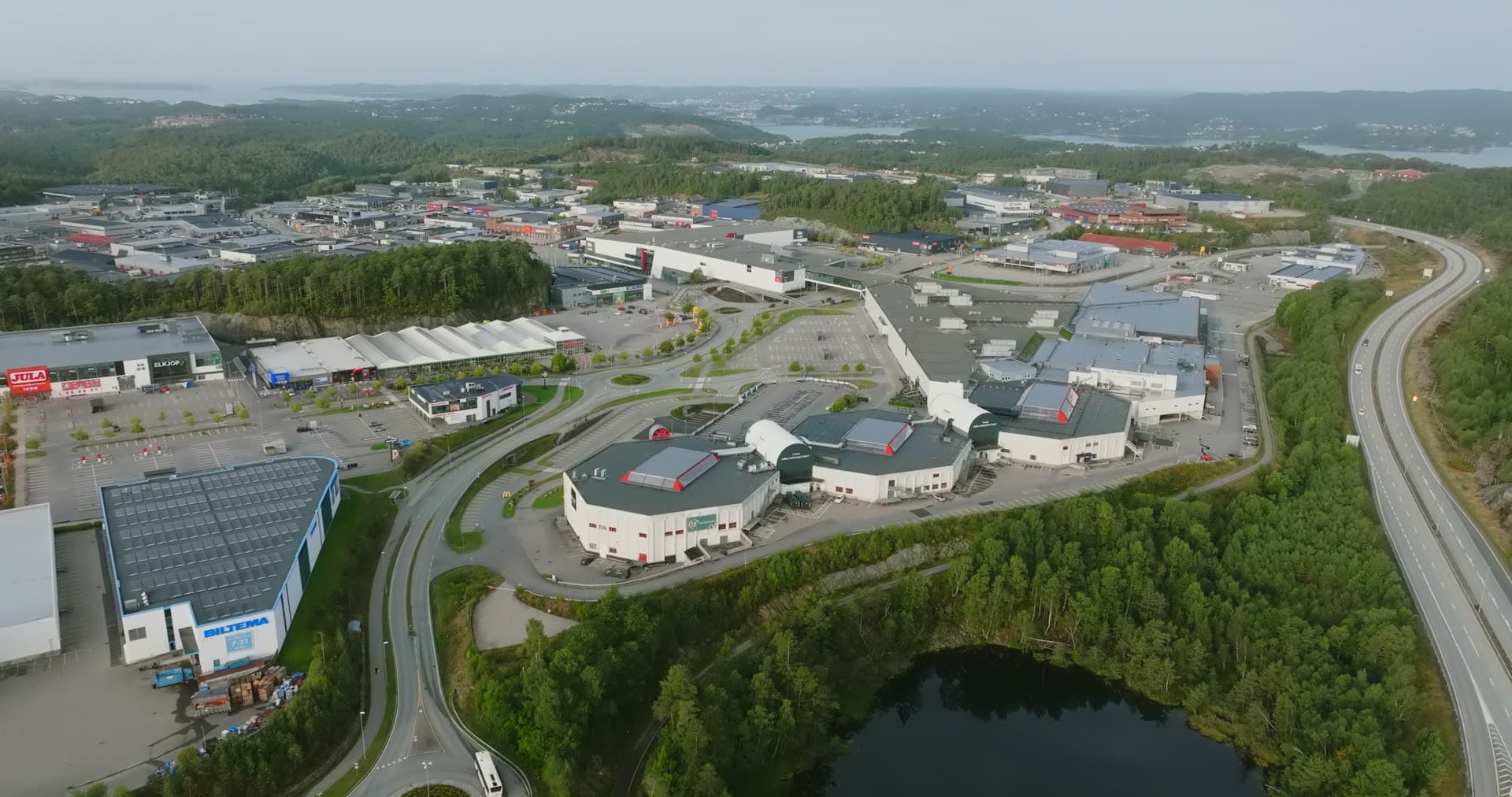 Modern arena structure with distinctive curved roof design, Sørlandsparken, Kristiansand, Norway